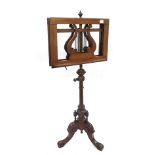 19th century walnut duet music stand, the bevelled ledges with pierced lyre backs upon adjustable