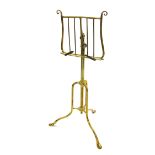 19th century brass music stand, the lyre backed ledge upon an adjustable tripod stand