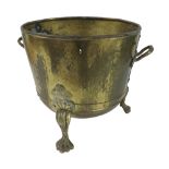 Circular planished brass fireside bucket, with applied twin handles over a riveted band and three