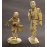 Japanese ivory okimono depicting a man holding a scroll, Meiji period, 8" high; together with