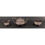 Late George III silver three piece tea service comprising teapot, milk jug and twin handled sucrier,