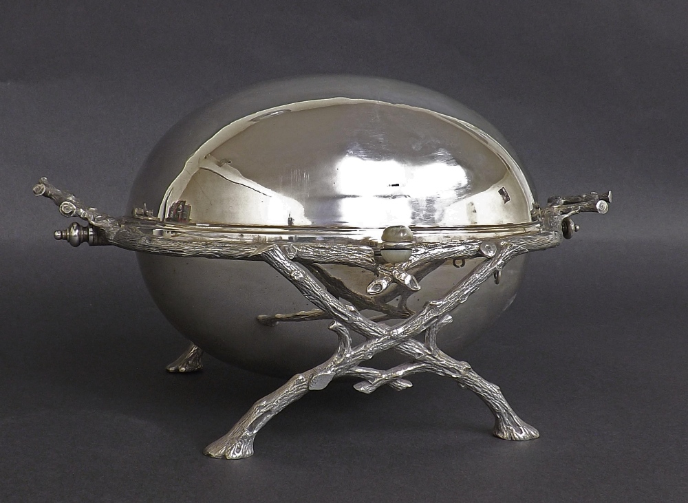 Attractive silver plated revolving breakfast dish, with fitted pierced tray interior upon a