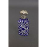 Victorian blue and clear cut glass scent bottle with a silver cover, 3" high