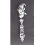 Novelty white metal baby's rattle in the form of Mr Punch, 6" long