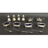 Extensive 1920s silver cruet set comprising four peppers, four salts and two mustards, with blue