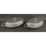 Pair of William IV silver oval twin handled entree dishes, the lids engraved with the Crest of a leg