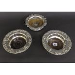 Pair of Victorian silver plated wine coasters, the rims embossed with grapes and vines upon turned