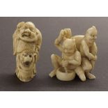 Japanese ivory netsuke modelled with two Oni, signed, 1.75" high; together with another netsuke (2)