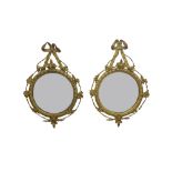 Pair of antique convex circular wall mirrors, with fancy giltwood gesso frames with tied ribbon