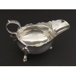 Edwardian silver sauceboat, with C-scroll handle and shell backed hoof feet, maker RMEH, Sheffield