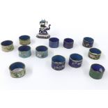 Collection of twelve various cloisonne napkin rings; together with an enamelled silver sculpture