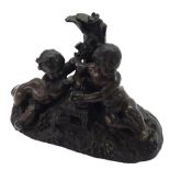 Small bronze group of good patination, modelled with two cherubs and birds sat upon a fruiting