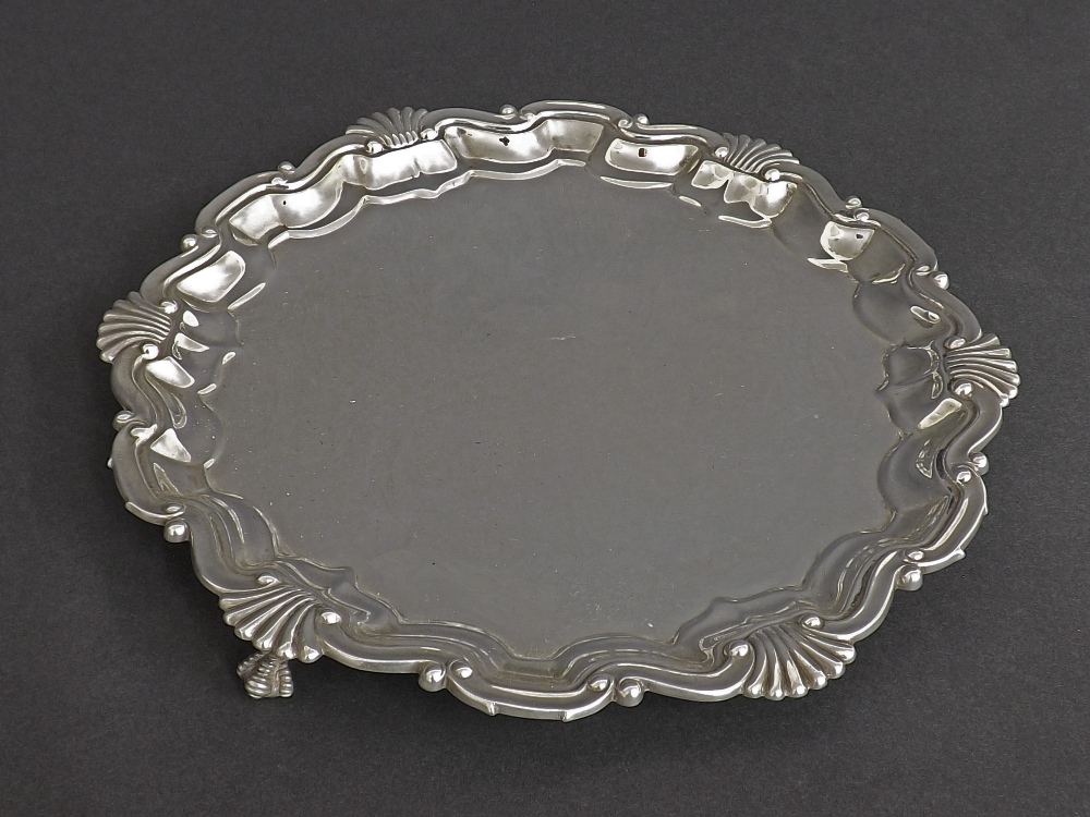 Early 20th century silver waiter with cast shell and cartouche rim, maker Skinner & Co., London