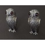 Pair of 0.800 silver novelty salt and pepper in the form of owls with red gemstone eyes, 3" high (