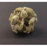 Japanese ivory netsuke depicting a huntsman and mystical bear, 2" high