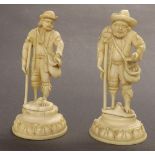 Two small similar 19th century carved ivory figures, modelled with men with peg legs  upon