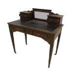 Edwardian rosewood writing table in the manner of Sheraton, the raised back fitted with a bevel