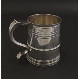 Edwardian silver S-scroll handle tankard with embossed bands, maker Holland, Aldwinckle & Slater,
