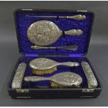 Late 19th/early 20th century cased dressing set made up of various brushes, combs and mirror, all