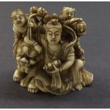 Good Japanese ivory okimono depicting three figures and a Buddhistic lion, inset signed red tablet