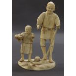 Japanese ivory okimono depicting a father and son, upon a naturalistic base, signed, Meiji period,