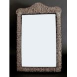 Edwardian silver mounted bevel edged easel mirror, embossed with scrolling cartouche, pierced with