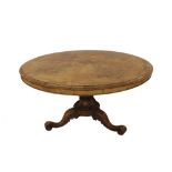 Victorian burr walnut circular loo table, the moulded quarter veneered tilt-top upon a bold turned