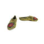 Pair of native American Indian moccasins, with beadwork of exotic flowers to the front