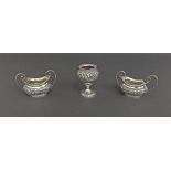 Pair of Victorian silver twin handled baskets (possibly salts) with embossed bowls of scrolled