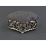 Edwardian pierced silver serpentine ring box/pin cushion pierced with scrolled foliage on four