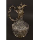 Silver plated and cut glass claret jug, the silver plated collar cast with rococo motifs to