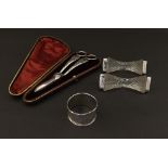 Mixed lot to include silver rimmed cut glass knife rests, silver napkin ring, silver plated grape