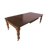 Victorian mahogany extending dining table, the moulded top upon four faceted baluster legs and brass