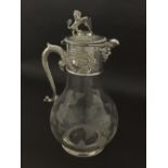 Silver plate and etched glass claret jug, the collar mounted by a lion holding a shield and embossed