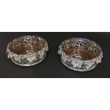 Pair of silver plated and turned hardwood wine coasters, cast with grapevine, each 8" diameter (2)