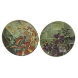 Pair of Arts & Crafts pottery wall chargers, hand painted with floral decoration, indistinct