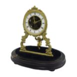 Gilt metal single train swing pendulum clock, the 3" chapter ring enclosing a skeletonised centre