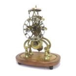 Brass single fusee skeleton clock with passing strike, the 4.75" pierced silvered dial supported