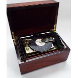 Contemporary Romance Swiss mahogany music box, together with six 4.5" discs, the hinged cover inlaid
