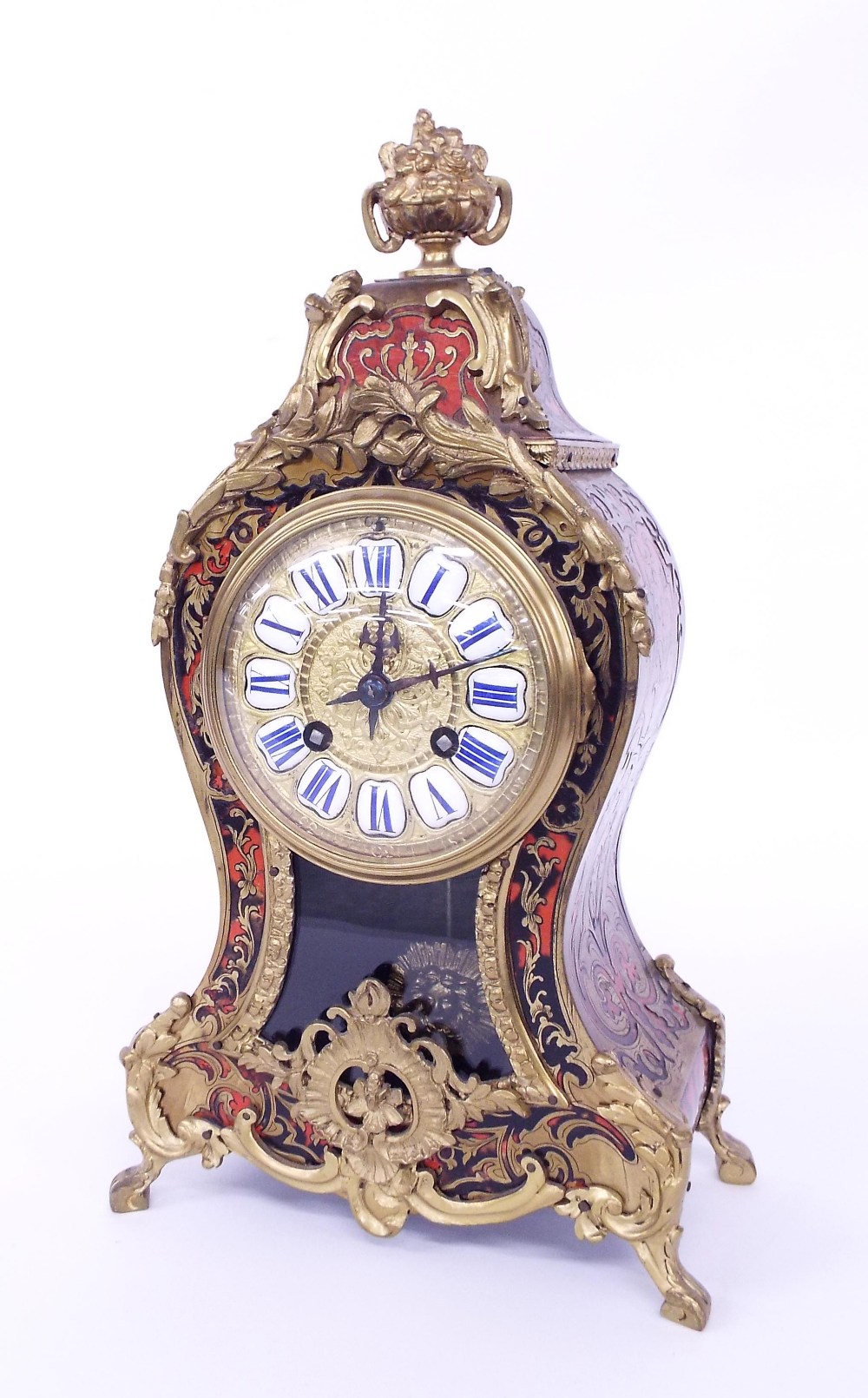 French Boulle two train mantel clock striking on a gong, the 3.75" gilt dial with Roman enamel