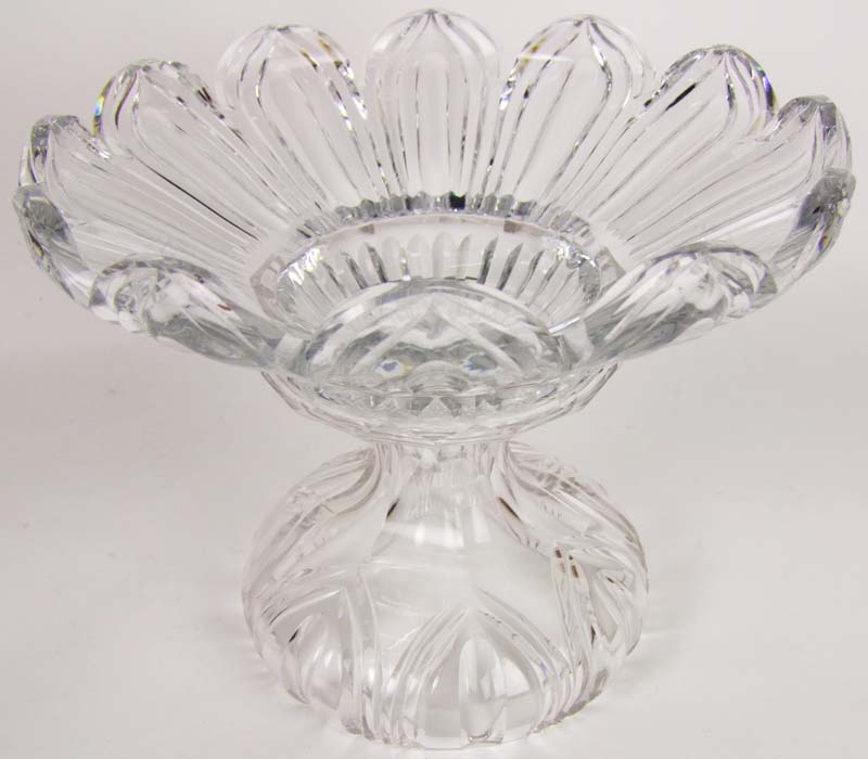 A cut glass bowl, in two parts, the lobed and tapered upper part on a waisted stem and domed base,