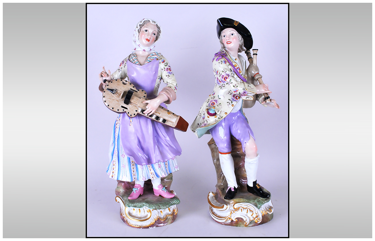 Pair of Meissen Street Musician Figures, both in 18th century attire, the lady dressed in
