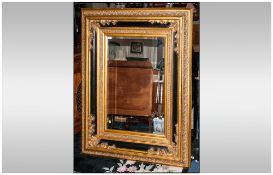 Large Reproduction Black Lacquered and Gilt Wall Mirror of Impressive size with floral moulded