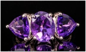 Amethyst Three Stone Ring, the central oval stone being 2.3cts, the trillion cuts to either side