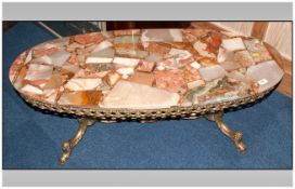 An Oval Onyx Topped Shaped Ormolu Base Coffee Table.