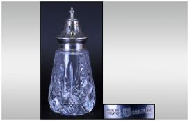 A Silver Topped Cut Glass Sugar Sifter of good quality. Hallmark Birmingham 1964. 6.25'' in height.