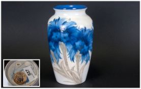 Moorcroft Blue Flowered Ovoid Vase, a wide band of flowers in shades of blue with pale green stems