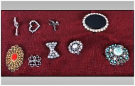 Collection Of Nine Brooches, Some Set With Coloured Stones, Others Marked For Silver.