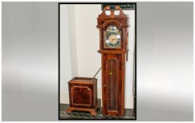 A Reproduction Walnut Cased, Glazed Door Front Grandfather Clock with a brass arched dial with a