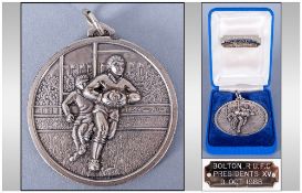 Bolton RUFC Presidents XV Silver Plated Medal, in original box, the medal showing a player running